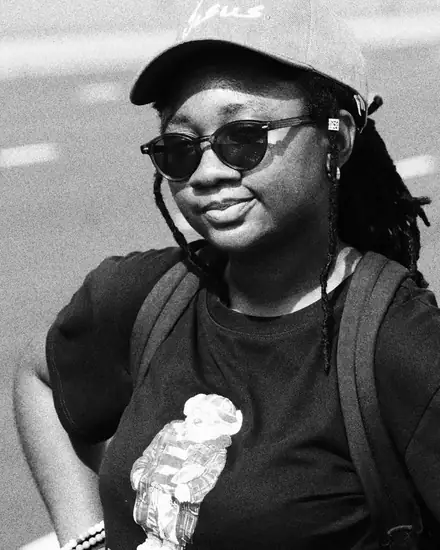 Dodoo smiling in a cap and sunglasses